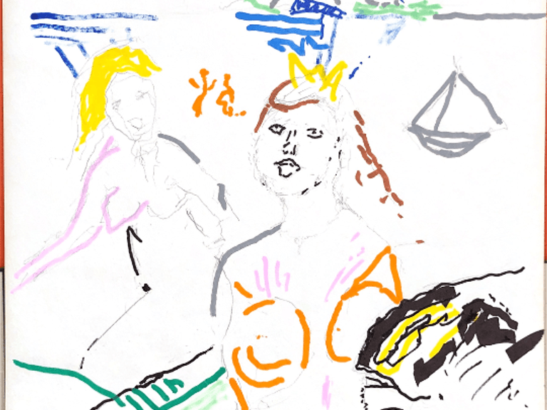 Two blondes on the beach in front of a volcano